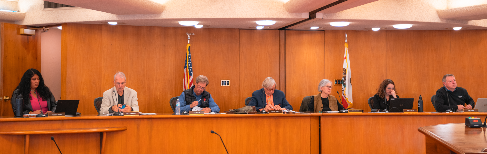Board members seated at the board of chambers.