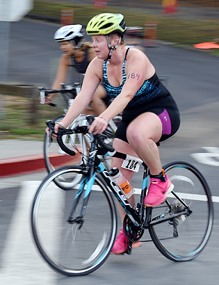 Two women riding bicycles in a road race.